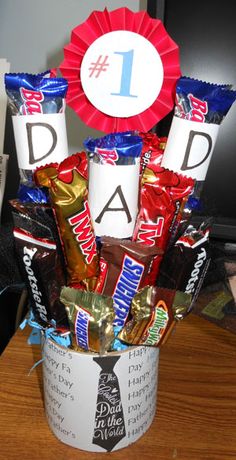 a father's day gift basket with candy, candies and an award ribbon