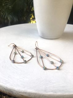 "Delicate but strong, handmade copper wire and Swarovski earrings, using 16g soft copper wire and Swarovski flatbacks. I shape the copper wire into a teardrop, solder the top joint, and add several strands of 22g wire. I place spots of solder on in the copper wire, hammer, and affix crystal flat backs to the solder and finish with a handmade earri wire. Size is approx 2.5\" long x 1.5 at the widest part. Very lightweight, sparkle beautifully when wearing. You can also remove the earring wire, tu Wire Wrapped Copper Teardrop Earrings, Wire Wrapped Copper Teardrop Dangle Earrings, Copper Wire Teardrop Earrings, Teardrop Wire Wrapped Wrap Earrings In Metal, Bronze Metal Teardrop Earrings, Nickel Free Teardrop Copper Wire Earrings, Nickel-free Copper Wire Teardrop Earrings, Adjustable Metal Teardrop Crystal Earrings, Bronze Wire Wrapped Teardrop Earrings