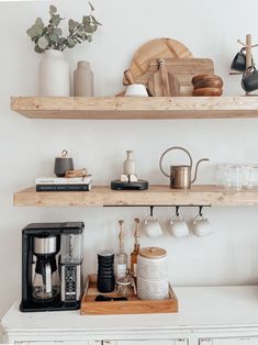 some shelves with coffee cups and other items on them