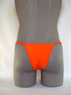 This string bikini gives you a contour fit with center seam to sculpture a great hard body definition,3/8 inch covered elastic waistband,1/4 inch elastic around the leg and double stitching Hand wash Nylon/Spandex Made in USA Orange Stretch Brief Swimwear, Fitted Red String Swimwear, Orange Nylon Swim Bottoms, 4-way Stretch Summer Swimwear Brief, Underwater Photoshoot, Micro-elastic Seamless Swimwear Brief, Body Builders, Hard Body, Body Builder