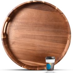 a wooden plate with a cup next to it