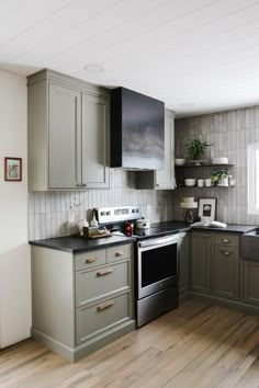 a kitchen with wooden floors and gray cabinets