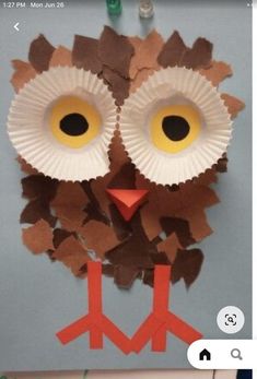 an owl made out of paper plates on a table