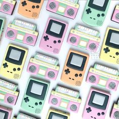 an array of colorful nintendo gameboy shaped magnets on a white surface with different colors and shapes