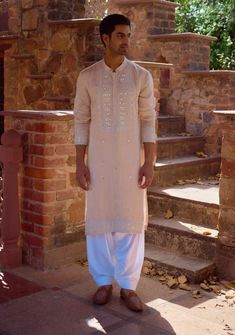 Experience traditional elegance with this hand-embroidered mirror work kurta in a soft sand beige color, crafted from a luxurious viscose cotton silk blend. The intricate mirror work is meticulously hand-stitched, creating a stunning design that reflects light beautifully, adding a touch of glamour to any occasion. Mirror Work Kurta, Intricate Mirror, Beige Kurta, Bespoke Tailoring, Sand Beige, Mirror Work, Cotton Silk, Beige Color, Hand Stitched