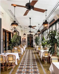 an indoor dining area with tables and chairs