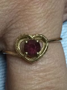 PRETTY 10K YELLOW GOLD GARNET HEART BAND RING Crafted of solid gold with a round garnet center stone Size 6.5 1.1 grams of solid 10k gold! Shipped insured/delivery confirmation I guarantee item to be exactly as described and pictured. Heirloom Gold Ruby Ring For Valentine's Day, Ruby Birthstone Heart Ring, Ruby Heart Ring With Birthstone, Valentine's Day Yellow Gold Ruby Ring, Yellow Gold Ruby Ring For Valentine's Day, Heirloom Ruby Ring For Valentine's Day, 14k Gold Ruby Ring For Anniversary, 14k Gold Ruby Ring With Round Stone For Anniversary, Round Ruby Birthstone Ring Stamped 14k