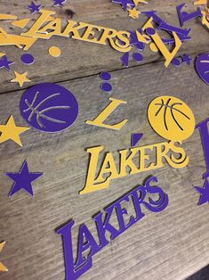 the lakers logo is made out of cutout wood and paper with stars around it