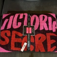 there is a pink and black towel on the couch