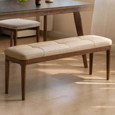 a wooden bench sitting in front of a table with vases on top of it