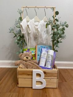 a teddy bear sitting in a wooden crate filled with personal care products and baby items