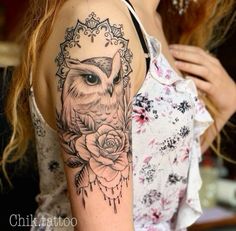 a woman with a tattoo on her arm has an owl and roses in the frame