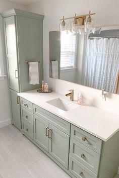 a bathroom with two sinks and a large mirror