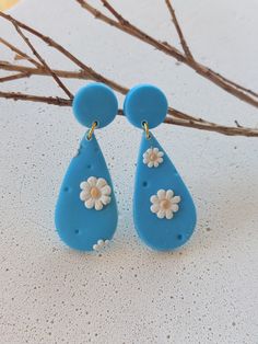 Handmade polymer clay earrings. Fresh Daisy Earrings with hand painted gold accents. Blue Clay Dangle Jewelry, Turquoise Dangle Earrings In Polymer Clay, Hand Painted Polymer Clay Flower Drop Earrings, Blue Dangle Flower Earrings In Polymer Clay, Handmade Resin Teardrop Earrings As Gift, Hand Painted Polymer Clay Drop Earrings, Handmade Polymer Clay Drop Earrings, Handmade Polymer Clay Dangle Flower Earrings, Handmade Clay Flower Drop Earrings