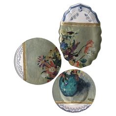 three plates with flowers painted on them