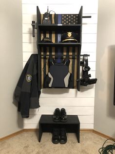 there is a coat rack and shoes in the corner next to a wall mounted shelf