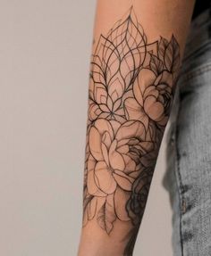 a woman's arm with a flower tattoo on it