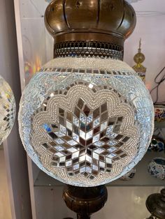 an ornate glass lamp is on display in a store