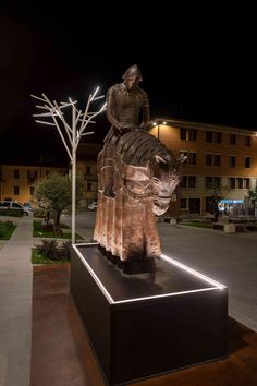 a statue of a woman sitting on top of a horse