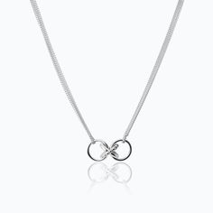 The X Diamonds Pendant is crafted by TANE in sterling silver with 8 round cut lab-grown diamonds with a total carat weight of 0.12. The central motif of the collection hangs from the double chain: two polished silver rings that come together in an X shape. One of the lines that intersects to form the X frames a row of diamonds. The piece takes its inspiration from the letter X, which is central to the word Mexico, in the same way that Mexico is central to the creative universe of TANE. As a seal Letter X, American Brand, Double Chain, Round Cut Diamond, Diamond Pendant, The Collection, Lab Grown, Lab Grown Diamonds, Round Cut