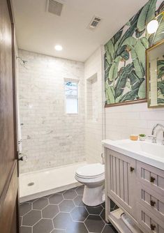 a bathroom with a white toilet sitting next to a bath tub