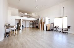 an empty room with hard wood floors and lots of storage space on the second floor