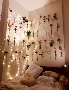 a bedroom with lights and flowers on the wall