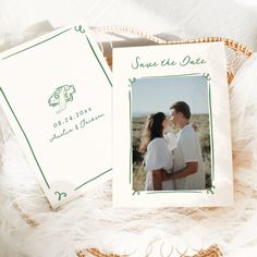 an image of a couple kissing on their wedding day with the save the date card next to them