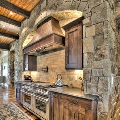 a kitchen with an oven, stove and counter top in it's center area