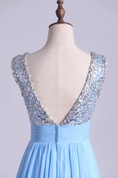 a blue dress with sequins on the back