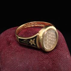 Beautiful Antique Victorian 18K Yellow Gold Enamel Hair Mourning Ring. This amazing ring has pristine enameling and the hair is still intact inside the glass. It has flower designs on the side of the ring without any damage which is rare. The inside of the ring is hallmarked.Item #R0926Metal: 18K Yellow Gold.Weight: 4 GramsRing Size: 8Measurements: Top measures 13 mm wide and band measures 2.8 mm wide.Measurement from finger to top of ring: 3.75  mmLayaway: For your convenience, we will be happy Vintage Gold Enamel Ring Stamped 14k, Black Enamel Ring For Wedding, Gold Oval Enamel Ring With Black Detail, Victorian Oval Enamel Ring For Anniversary, Antique Yellow Gold Signet Ring With Black Enamel, Antique Enamel Ring Collectible, Formal Black Enamel Oval Ring, Formal Oval Enamel Ring With Black Enamel, Formal Engraved Enamel Signet Ring