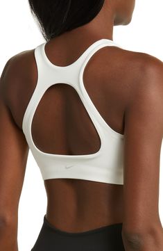 Get into your groove in this ultracomfy sports bra with signature Dri-FIT tech and a breezy back cutout to keep you cool and dry. Racerback Dri-FIT moisture-wicking technology Lined 80% polyester, 20% elastane Machine wash, line dry Imported Nike Sports Bra With Built-in Padding, Nylon Activewear With Built-in Bra For Sports, Nike Activewear With Built-in Padding For Sports, Nike Activewear With Built-in Bra For Workout, White Nylon Sports Bra With Built-in Bra, Nike Sweat Resistant Activewear For Yoga, White Nylon Activewear With Built-in Padding, Nike Sweat-resistant Activewear For Yoga, Supportive Nike Sports Bra