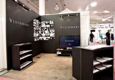 an exhibit room with black walls and white curtains