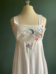 "This Dress !! A great light weight white cotton dress with the perfect amount of embroidered detail on the bodice, empire style with nice wide straps a side zipper for easy on and off and a stretchy back to make sizing easy  - tired eyelet detail bottom  - vintage size 11 please look at measurements  -Made by Young Edwardian circa 1960's -70's -Washed and ready to wear  Measurements laying flat: Underarm to underarm 17\" Length 59\" at empire 13\" (with additional stretch)  There is lots of stretch to this Dress fits size Small to Medium" White Cotton Embroidered Dress For Vacation, White Embroidered Cotton Dress For Vacation, Vacation Cotton Dress With Floral Embroidery, Floral Embroidered Cotton Dress For Vacation, White Cotton Embroidered Dress For Garden Party, Cotton Embroidered Dress With Floral Embroidery For Vacation, Sleeveless Cotton Embroidered Dress For Garden Party, Summer Embroidered Cotton Dress For Garden Party, Summer Cotton Embroidered Dress For Garden Party