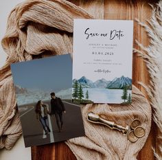 a couple's save - the - date card, key, and other items are laid out on a table