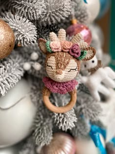 a close up of a christmas tree with ornaments on it and a giraffe ornament