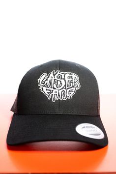 Embroidered mesh-backed trucker hat, with adjustable size.  Featuring Laserfang logo by Todd Williams.  Looking cool as heck guaranteed. Cheap Black Trucker Hat With Embroidered Logo, York Pa, Maisie Williams, Trucker Cap, Caps Hats, Trucker Hat, Accessories Hats, Bathing Beauties, Mesh