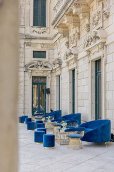 blue chairs are lined up in front of a building