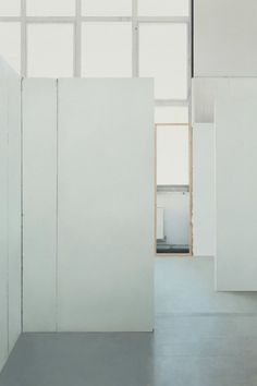 an empty room with white walls and doors