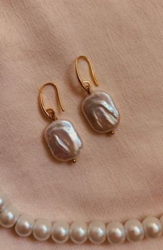 Discover the timeless elegance of these handcrafted gold earrings decorated with a genuine freshwater pearl pendant. Each piece has been crafted with the utmost care and attention to detail to offer you a unique piece of jewelry that enhances your beauty in a subtle yet remarkable way. The warm gold color of the earrings gives them a touch of luxury and sophistication, while the natural beauty of the freshwater pearls adds a touch of grace and delicacy. Each pearl is unique in its shape and colo Handmade Delicate Pearl Earrings, Gold Teardrop Pearl Earrings As A Gift, Gold Teardrop Pearl Earrings For Gift, Everyday Pearl Pendant Drop Earrings, Classic Pearl Pendant Earrings In 14k Gold Filled, Gold Dangle Pearl Earrings As Gift, Gold Drop Pearl Earrings For Gift, Handmade Dainty Pearl Earrings, Handmade Gold Pearl Earrings As A Gift