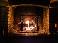 a fire place in a fireplace lit by candles