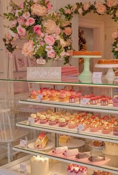 a bakery filled with lots of different types of cakes and cupcakes on display