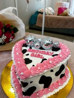 a heart shaped birthday cake on a table