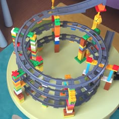 a toy train set with legos on the tracks