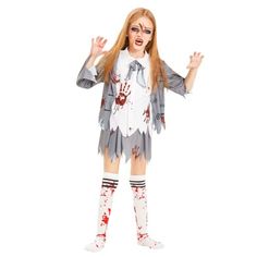 a woman dressed as a zombie holding her hands out