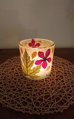 a lit candle sitting on top of a doily