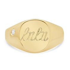 a yellow gold signet ring with the word blkr engraved in cursive font