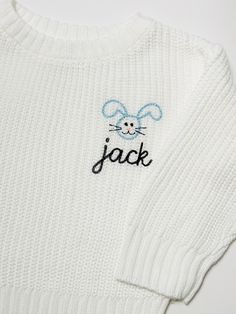 a white sweater with the word jack on it and a mouse embroidered on the front