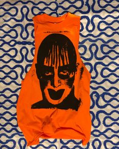 Leigh Bowery...what more can I say.  Screen Printed on a "Hazard Orange" Gildan Brand T-Shirt with Black Water Based Fabric Ink. Marked with the Jeff Chiola logo on the back. Additional sizes are available upon request.  *This item is hand printed each shirt is made to order making each piece unique.   Sizes XL and above are extra $2.00. First the first wash: Inside out and in cold water.  The ink will become softer with wear & wash. Alternative Cotton Top With Funny Print, Funny Print Cotton Top In Alternative Style, Alternative Cotton Tops With Funny Print, Alternative Cotton T-shirt With Funny Print, Unisex Screen Print Tops For Alternative Fashion, Alternative Style Screen Print Tops For Summer, Funny Print Cotton T-shirt For Alternative Fashion, Orange Graphic Design Tops For Summer, Orange Graphic Design Top For Summer