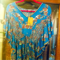 Nwt Sky & Sand Blue & Peach Floral Print Flutter Sleeve Babydoll Top Size Large Beautiful Cut Extremely Flattering Fit & Colors 100% Rayon Pit To Pit: 19 Length: 29 Layered V-Neck With Full Flutter Sleeves New With Tag Create A Bundle By Selecting The Items You Wish To Purchase Underneath The Listing To Receive A Discount And Pay Only One Shipping Fee L150 Blue Ruffled Dresses For Festival, Blue Butterfly Sleeve Beach Dress, Blue Beach Dress With Butterfly Sleeves, Blue Butterfly Sleeve Dress For Beach, Blue Boho Print Short Sleeve Tops, Blue Summer Dress With Butterfly Sleeves, Summer Blue Dress With Butterfly Sleeves, Cold Shoulder Bodysuit, Bishop Sleeve Blouse